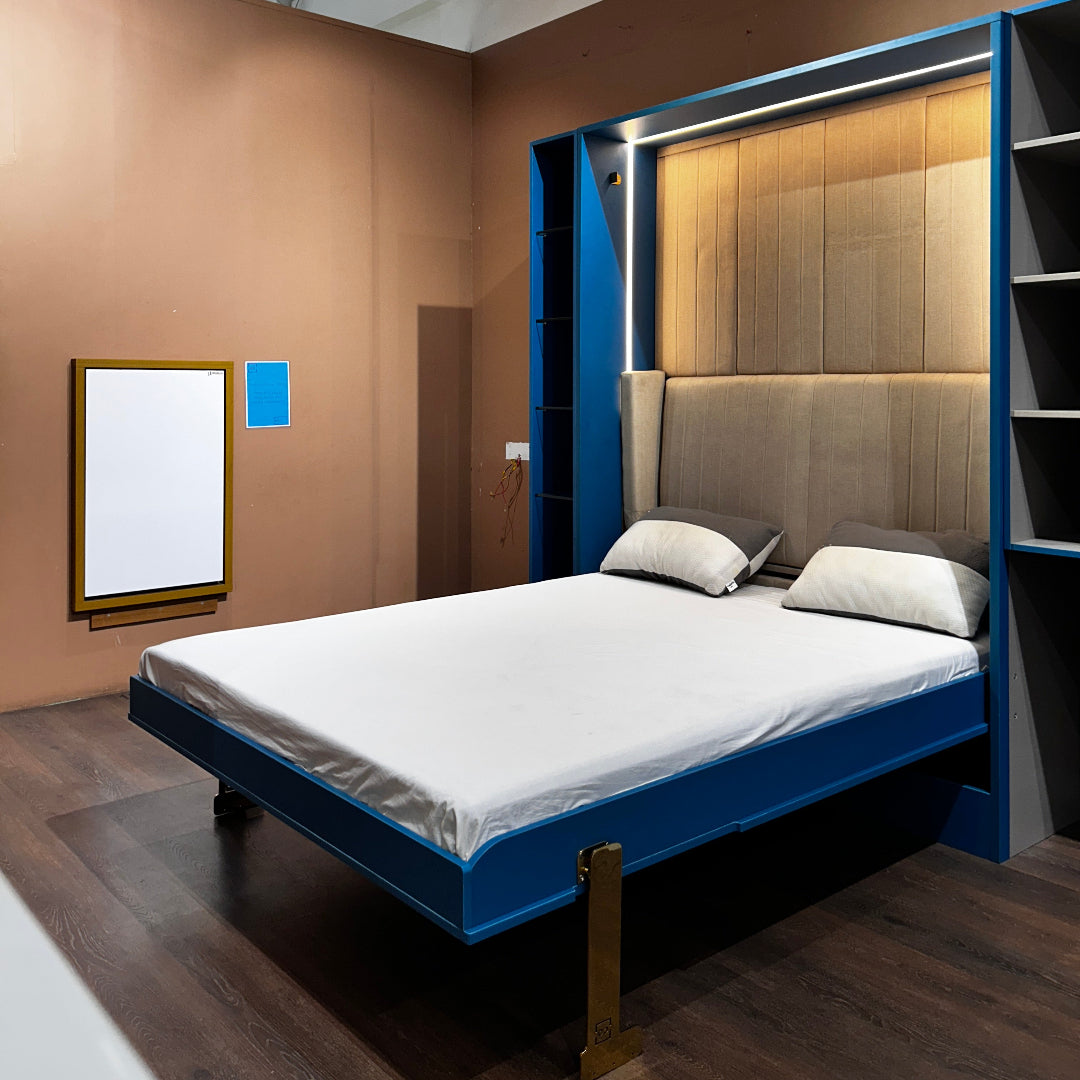 A modern bedroom featuring an electric invisible bed with a blue frame, neatly stored against the wall when not in use, in a room with a minimalist decor.